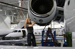 tech working on airplane engine